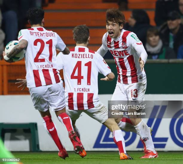 Yuya Osako of Koeln celebrates his team's first goal with team mates Vincent Koziello and Leonardo Bittencourt during the Bundesliga match between SV...