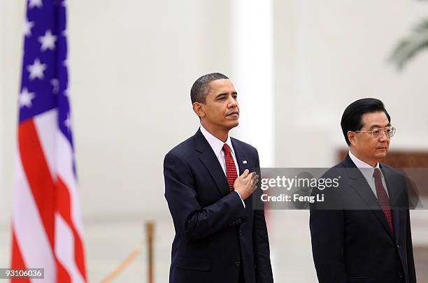 China's President Hu Jintao and U.S. President Barack Obama listen to national anthems during a welcome ceremony at the Great Hall of the People on...