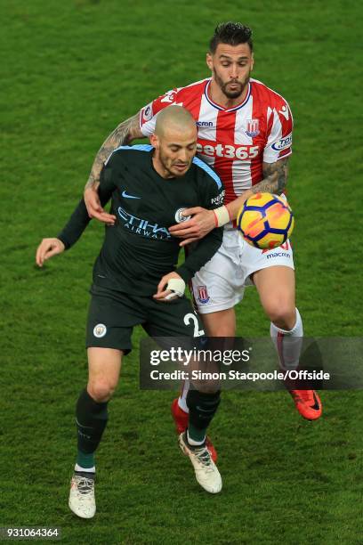 David Silva of Man City battles with Geoff Cameron of Stoke during the Premier League match between Stoke City and Manchester City at the Bet365...