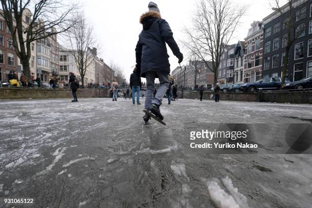 Ice skater enjoy on the frozen Keizersgracht canal on March 3 in Amsterdam, The Netherlands.