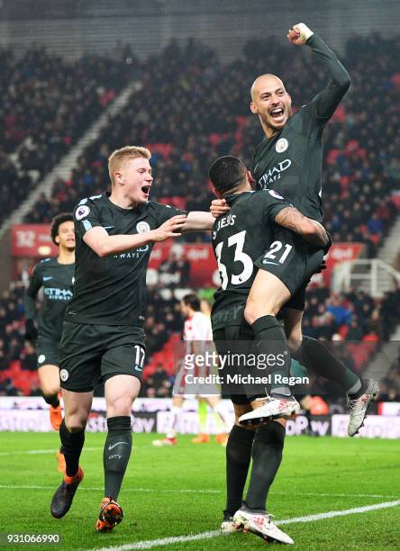 David Silva of Manchester City celebrates as he scores their second goal with Kevin De Bruyne and Gabriel Jesus during the Premier League match...