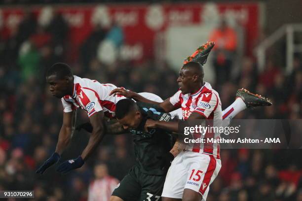 Kurt Zouma of Stoke City and Gabriel Jesus of Manchester City and Bruno Martins Indi of Stoke City during the Premier League match between Stoke City...