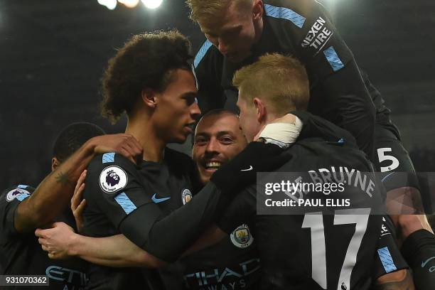 Manchester City's Spanish midfielder David Silva celebrates with teammates after scoring his second goal of the English Premier League football match...