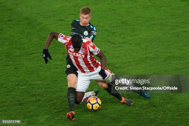 Kevin De Bruyne of Man City battles with Papa Alioune Ndiaye of Stoke during the Premier League match between Stoke City and Manchester City at the...