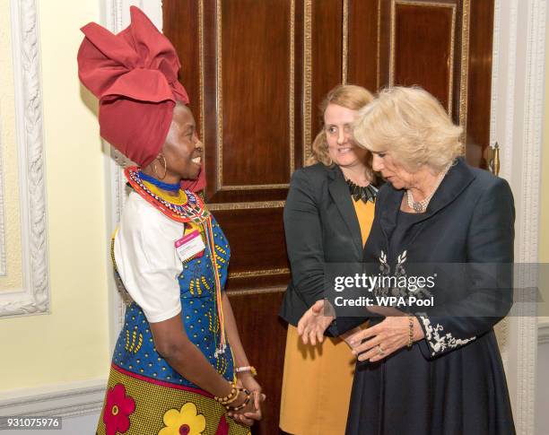 Camilla, Duchess of Cornwall meets a guest during the 2018 Commonwealth Day reception at Marlborough House on March 12, 2018 in London, England.
