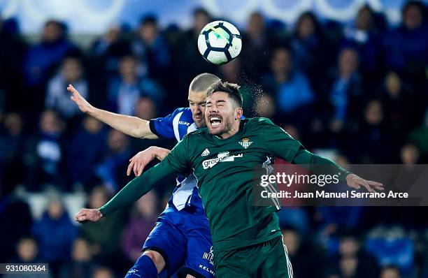 Javi Garcia of Real Betis Balompie duels for the ball with Victor Laguardia of Deportivo Alaves during the La Liga match between Deportivo Alaves and...