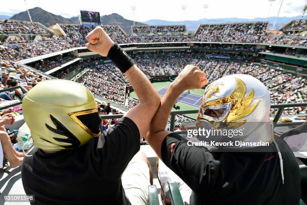 Fans wearing Mexican wrestler masks watch the tennis match between Roger Federer of Switzerland and Filip Krajinovic of Serbia during Day 8 of BNP...