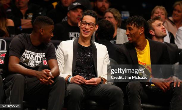 Jeremy Lin of the Brooklyn Nets has a laugh on the bench during a game against the Los Angeles Lakers with teammates Caris LeVert and Rondae...