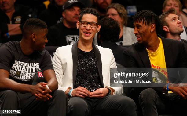 Jeremy Lin of the Brooklyn Nets has a laugh on the bench during a game against the Los Angeles Lakers with teammates Caris LeVert and Rondae...