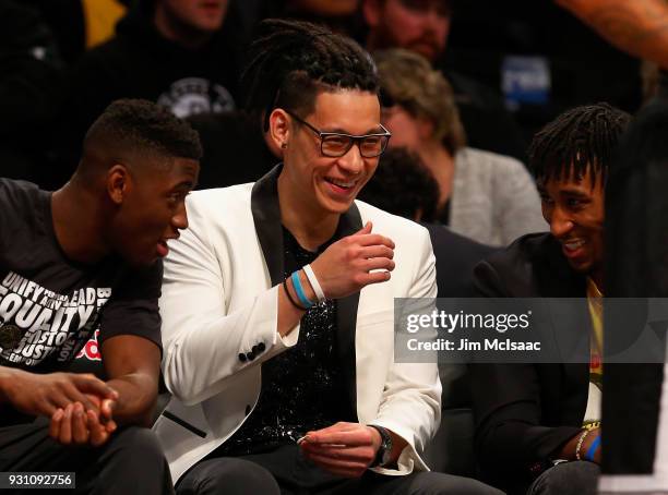 Jeremy Lin of the Brooklyn Nets has a laugh on the bench during a game against the Los Angeles Lakers with teammates Caris LeVert and Rondae...