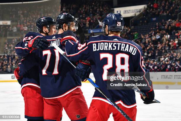 Nick Foligno of the Columbus Blue Jackets celebrates his first period goal with teammates Markus Nutivaara and Oliver Bjorkstrand of the Columbus...