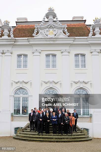 Germany's new cabinet poses for a group photo as they meet for a closed-door cabinet meeting in Meseberg, north of Berlin, on November 17, 2009....