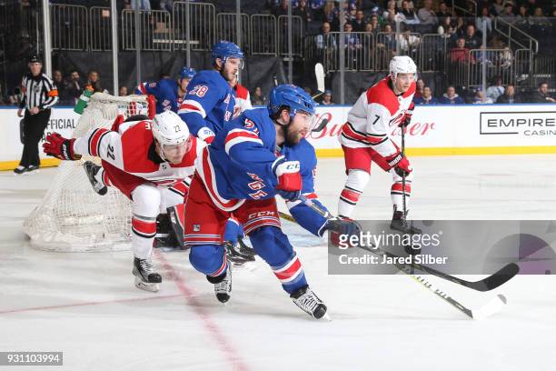 David Desharnais of the New York Rangers skates against Brett Pesce of the Carolina Hurricanes at Madison Square Garden on March 12, 2018 in New York...