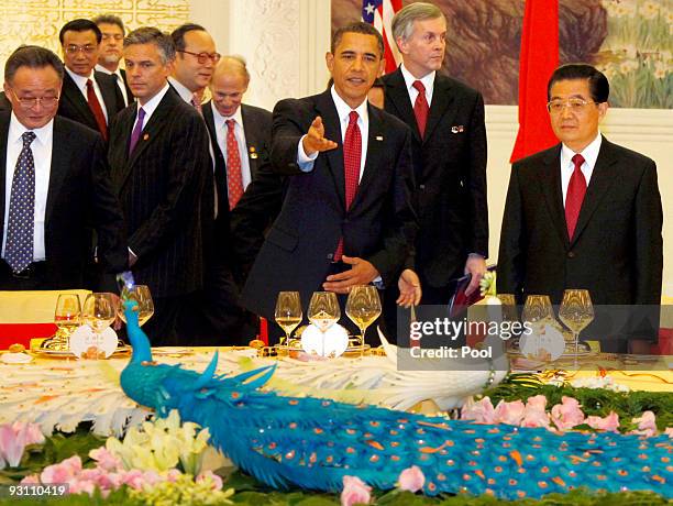 Chinese President Hu Jintao listens to U.S. President Barack Obama during an official welcoming dinner in the Great Hall of the People on November...