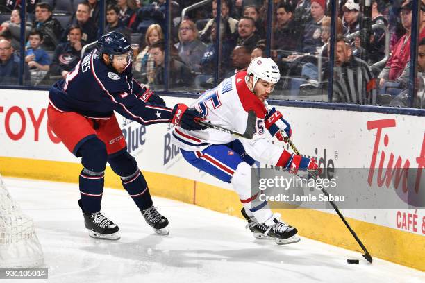 Andrew Shaw of the Montreal Canadiens attempts to keep the puck from Seth Jones of the Columbus Blue Jackets during the second period of a game on...