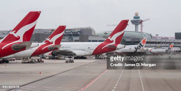 Five Qantas and Jetstar aircraft lined up at Changi Airport on March 12, 2018 in Singapore. Qantas has signed a new partnership with the Singapore...