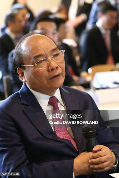 Vietnam's Prime Minister Nguyen Xuan Phuc looks on during a visit to the Plant and Food Research head office in Auckland on March 13, 2018. / AFP...