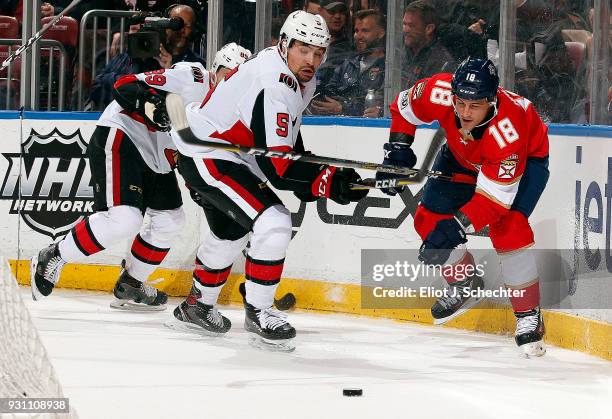 Cody Ceci of the Ottawa Senators crosses sticks with Micheal Haley of the Florida Panthers at the BB&T Center on March 12, 2018 in Sunrise, Florida.