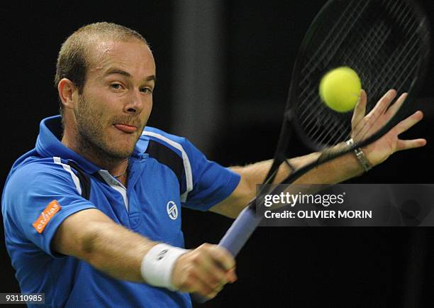 Belgian Olivier Rochus returns the ball on October 24, 2009 to Brazilian Thomaz Bellucci during the semi-final of the Stockholm Open in the Swedish...