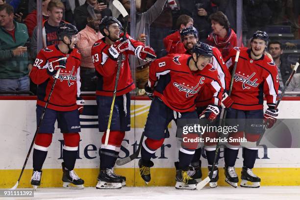 Alex Ovechkin of the Washington Capitals celebrates with teammates after scoring his 600th career goal against the Winnipeg Jets during the second...