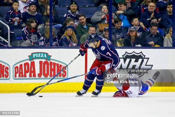 Paul Byron of the Montreal Canadiens attempts to knock the puck away from Jack Johnson of the Columbus Blue Jackets during the second period on March...