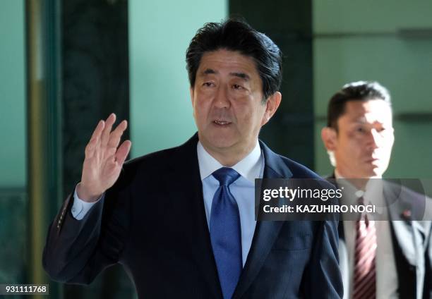 Japan's Prime Minister Shinzo Abe arrives at the prime minister's official residence to attend a cabinet meeting in Tokyo on March 13, 2018. Japan's...