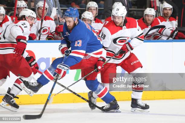 Elias Lindholm of the Carolina Hurricanes skates against Kevin Hayes of the New York Rangers at Madison Square Garden on March 12, 2018 in New York...