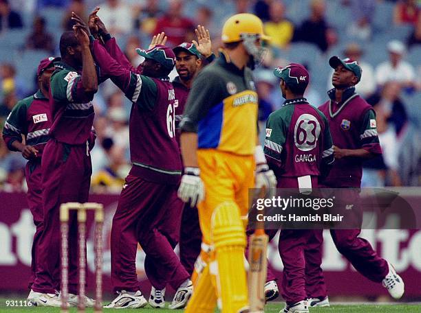 Mark Waugh of Australia leaves the field after he was caught by Brian Lara of the West Indies off the bowling of Marlon Samuels of the West Indies...