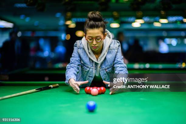 In this picture taken on March 9 women's snooker world champion Ng On-yee of Hong Kong arranges balls on a snooker table during an interview with AFP...