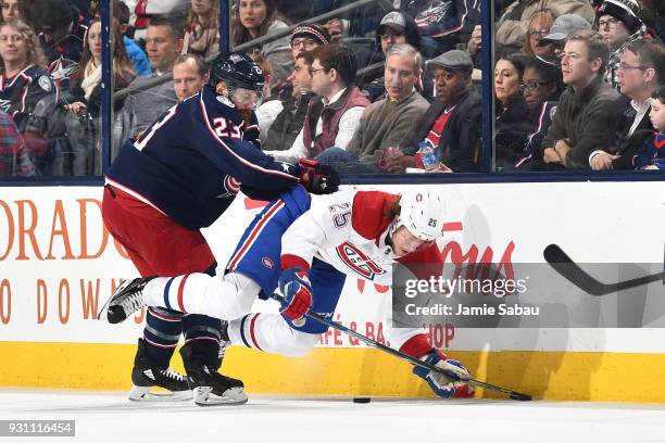 Ian Cole of the Columbus Blue Jackets knocks Jacob De La Rose of the Montreal Canadiens off the puck during the third period of a game on March 12,...