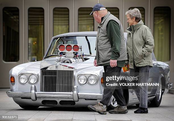 Visitors look at a Rolls Royce "Silver Shadow" car with a tuned 1300-horsepower engine, which is, according to its owner, worth 700,000 US dollars,...