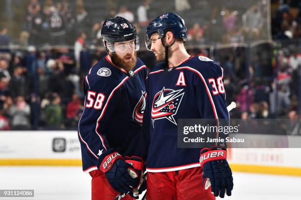 David Savard of the Columbus Blue Jackets talks with teammate Boone Jenner of the Columbus Blue Jackets prior to a face-off during the third period...