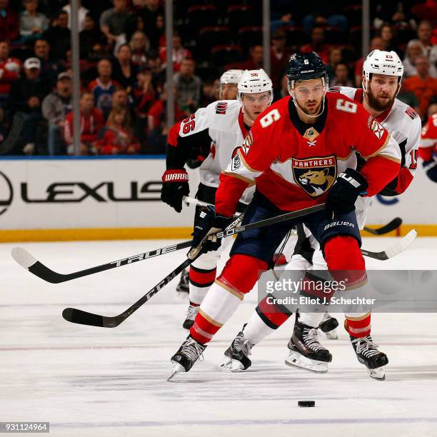 Alex Petrovic of the Florida Panthers skates for possession against Zack Smith of the Ottawa Senators at the BB&T Center on March 12, 2018 in...
