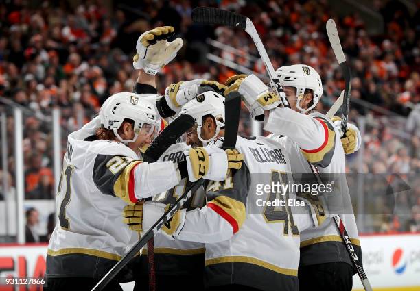 Ryan Carpenter of the Vegas Golden Knights is congratulated by teammates Cody Eakin and Pierre-Edouard Bellemare of the Vegas Golden Knights after he...
