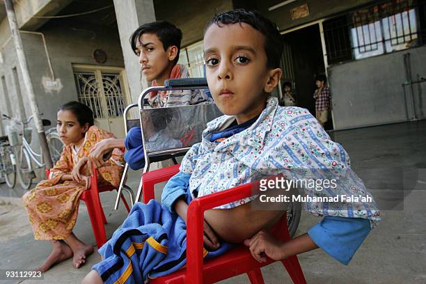 Yousif Hamed, age 4 years old, his brother Anas Hamed and his sister Inas who suffer from birth defects are pictured on November 12, 2009 in the city...