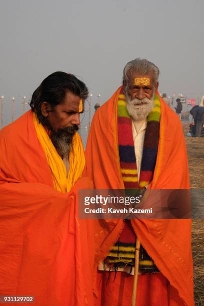 Two Hindu Sadhus wearing orange colors seen after a holy dip in Sangam during Magh Mela Festival on January 27, 2018 in Allahabad, India. Sangam is...