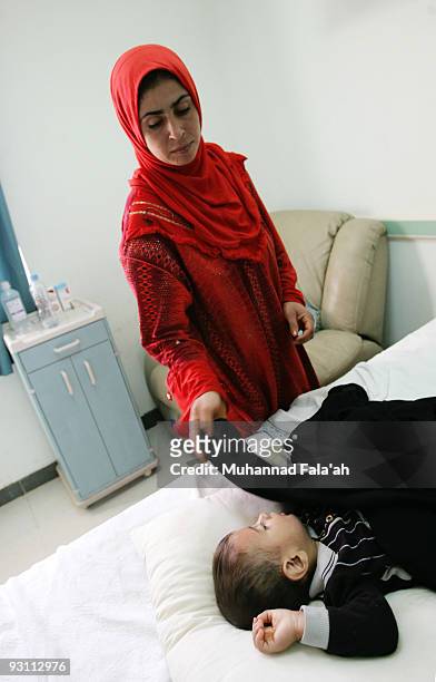 An Iraqi woman attends to her sick son on November 12, 2009 at Falluja General Hospital in the city of Falluja west of Baghdad, Iraq. Birth defects...