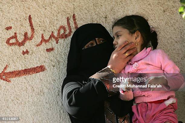Mariam Yasir, age 6 years old, who suffers from a birth defect is held by her mother on November 12, 2009 in the city of Falluja west of Baghdad,...