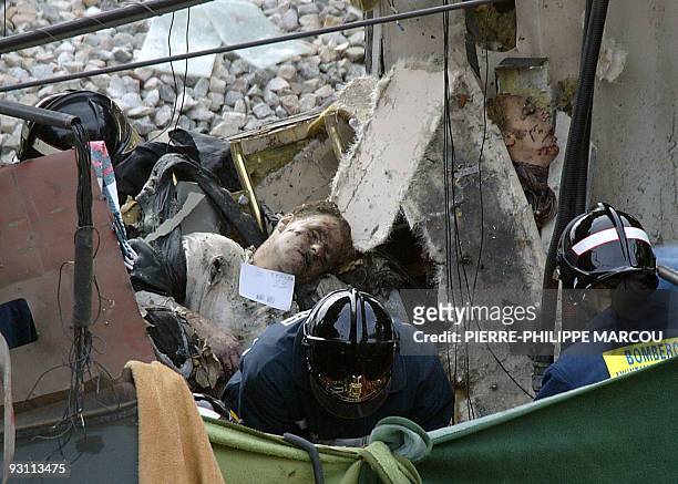Rescue workers free bodies from the train after it exploded at the Atocha train station in Madrid 11 March 2004. At least 173 people were killed and...