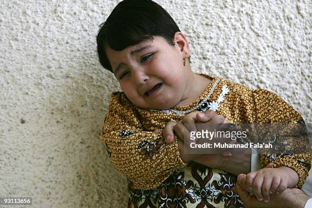 Zahra Muhammad, age 4 years old, who suffers from a birth defect is held by her father on November 12, 2009 in the city of Falluja west of Baghdad,...