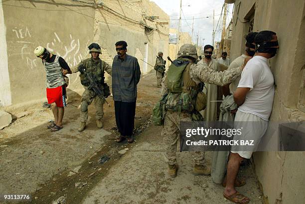 Marines from the 3/5 Lima company takes away suspected insurgent in the Jolan district of the restive city of Fallujah 12 November 2004, 50 kms west...
