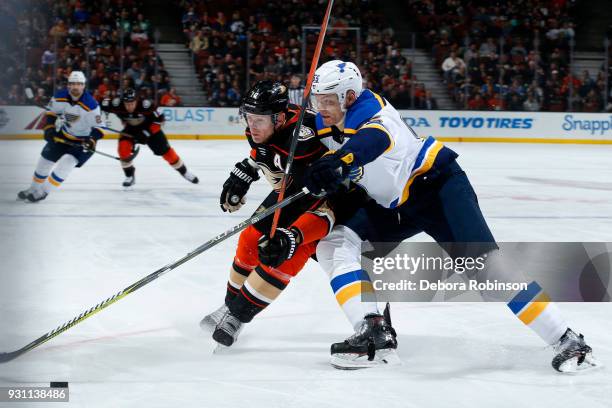 Corey Perry of the Anaheim Ducks battles for the puck against Colton Parayko of the St. Louis Blues during the game on March 12, 2018 at Honda Center...
