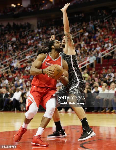 Nene of the Houston Rockets drives around Joffrey Lauvergne of the San Antonio Spurs at Toyota Center on March 12, 2018 in Houston, Texas. NOTE TO...