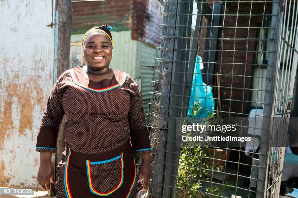 smiling mother standing outdoors - rural african people stock pictures, royalty-free photos & images