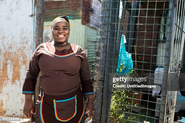 smiling mother standing outdoors - slum africa stock pictures, royalty-free photos & images