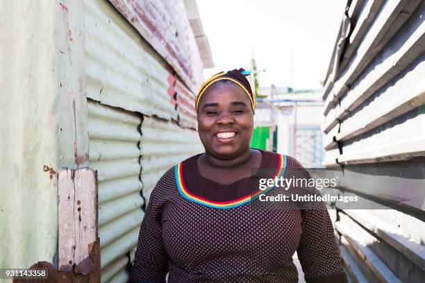 smiling mother standing outdoors - rural african people stock pictures, royalty-free photos & images