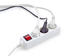 Power strip with three connected power plugs with corresponding cables
