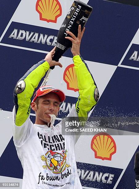 World Champion Italian rider Valentino Rossi of Fiat Yamaha celebrates defending his seventh Moto GP title on the podium of the Malaysian Motocycle...