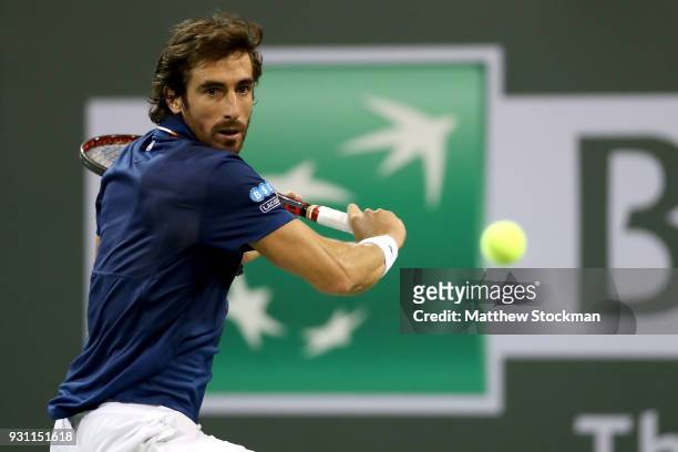 Pablo Cuevas of Uraguay returns a shot to Dominic Thiem of Austria during the BNP Paribas Open at the Indian Wells Tennis Garden on March 12, 2018 in...