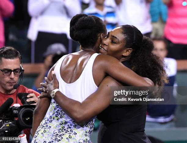 Serena Williams hugs Venus Williams after her loss to her sister during Day 8 of BNP Paribas Open on March 12, 2018 in Indian Wells, California....